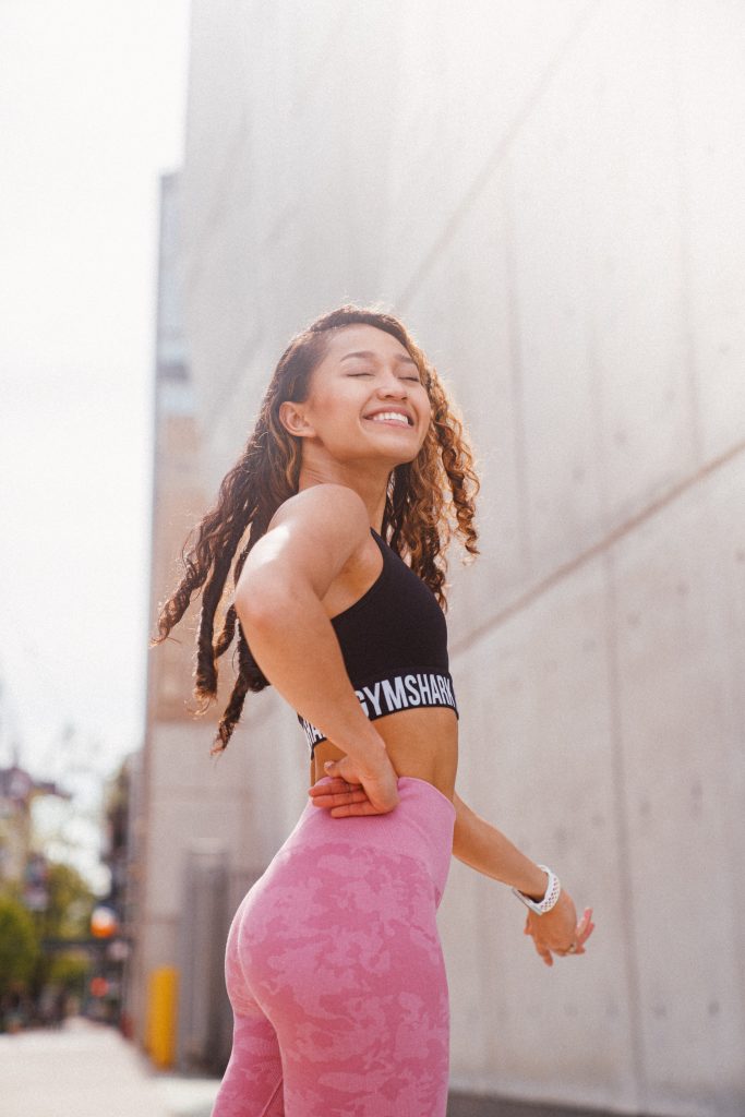 a girl wearing active wear and smiling