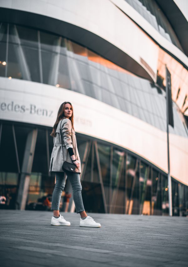 a girl in front of the mercedes benz museum