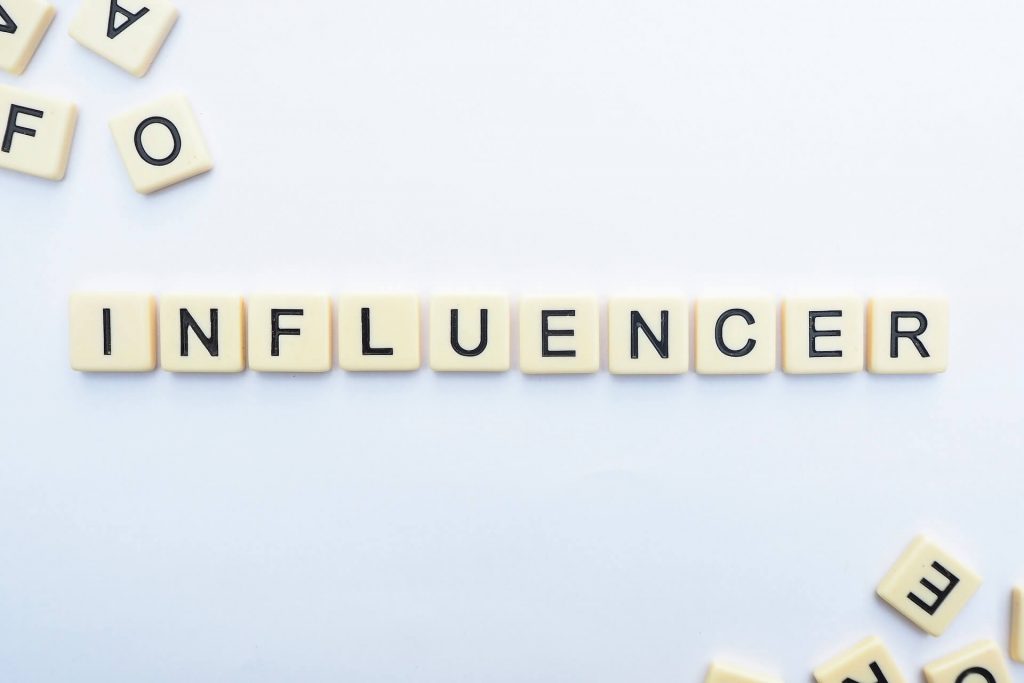 scrabble letters spelling out influencer
