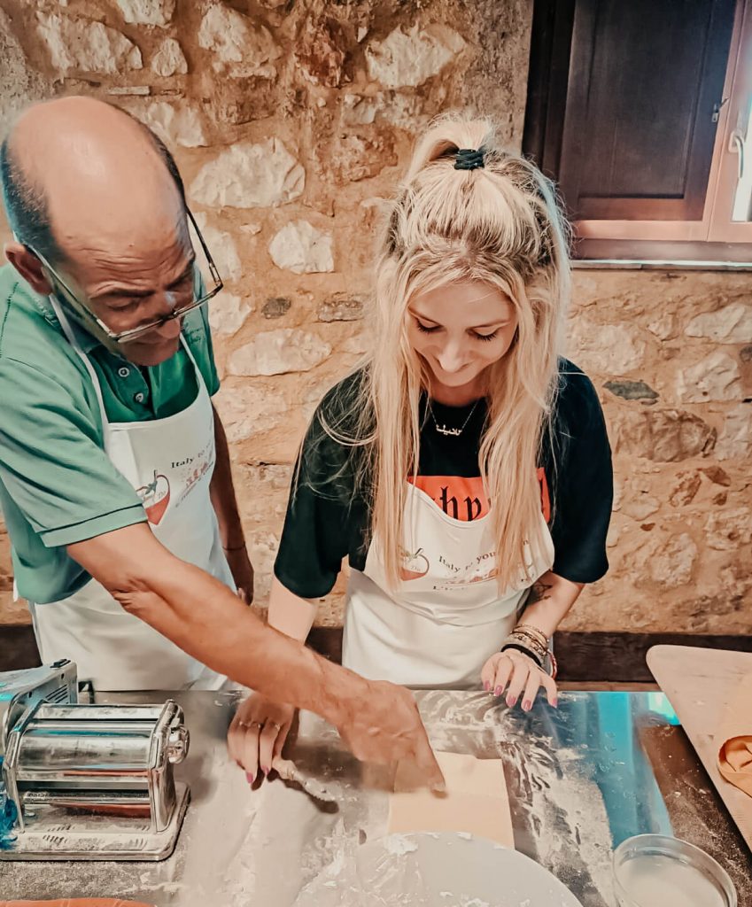a girl and a man making fresh pasta