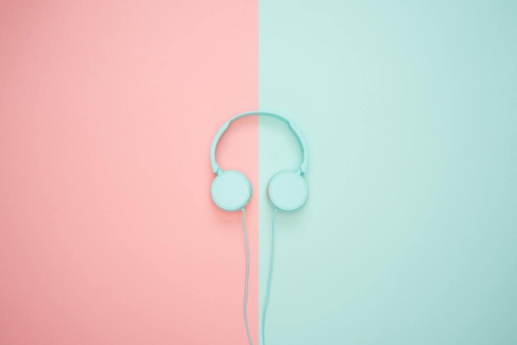 blue headphones on a pink and blue background