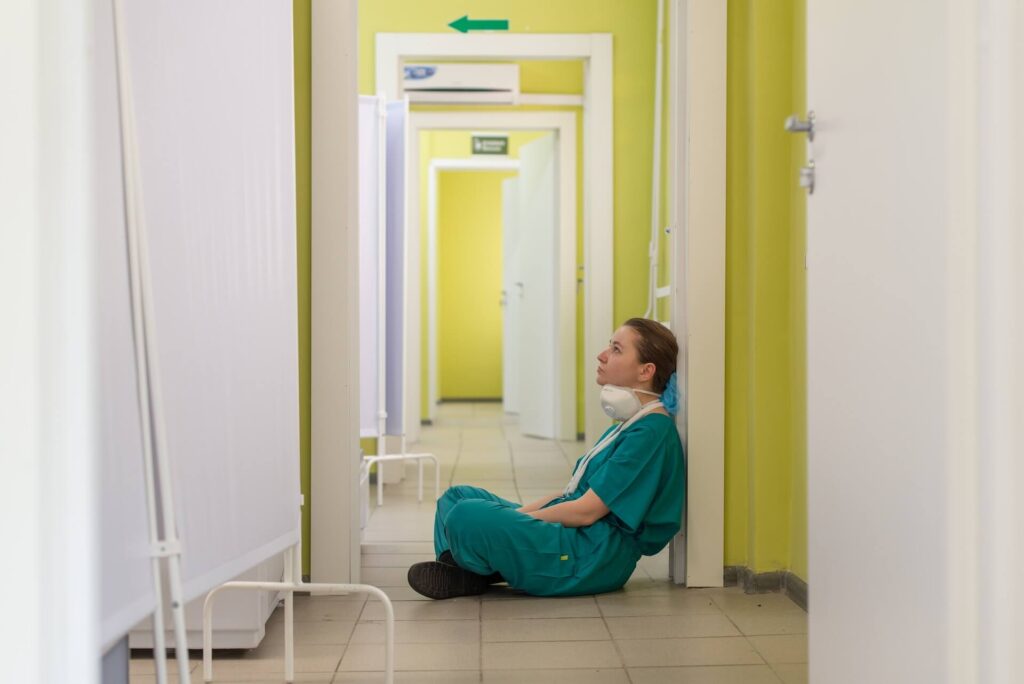 a female nurse sitting on the floor